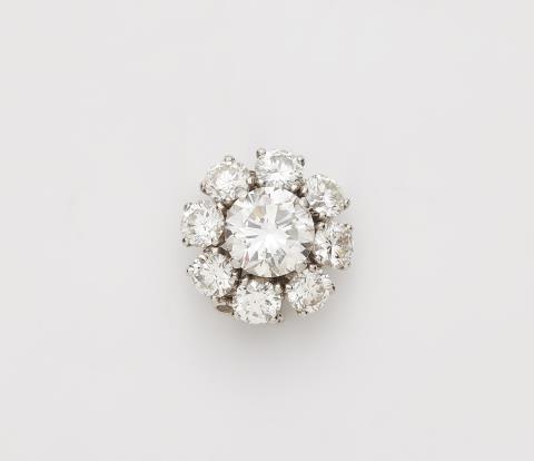 
    
            
                    An 18k white gold and diamond pendant attached to a fine link chain. Can also be worn as a clip with a hinged double pin.
                
        

