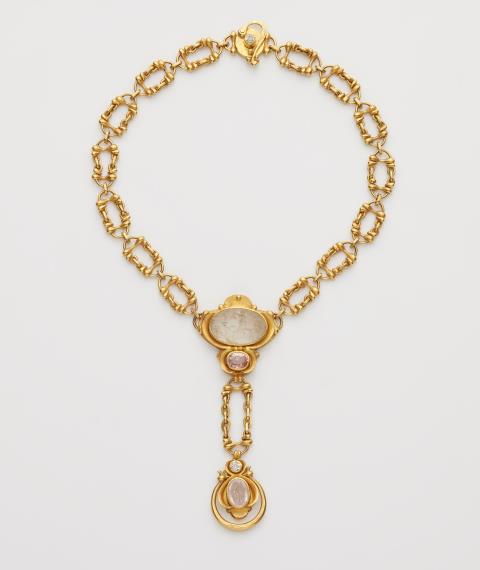 
    
            
                    A signed German handforged 22 gold pink sapphire and diamond pendant necklace with swivel ring mounted with two ancient Roman rock crystal intaglios.
                
        
