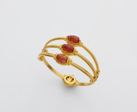 
    
            
                    An Archeological Revival 18k gold and carnelian scarab bangle.
                
        
