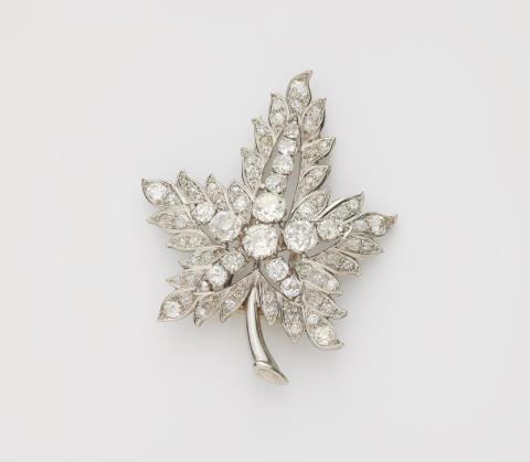 
    
            
                    A French platinum 18k white gold and diamond Retro Style maple leaf clip brooch.
                
        

