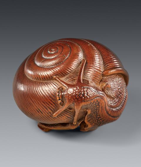 
    
            
                    A large wood netsuke of a large snail by Naitō Toyomasa (1773-1856), dated by inscription 1840
                
        
