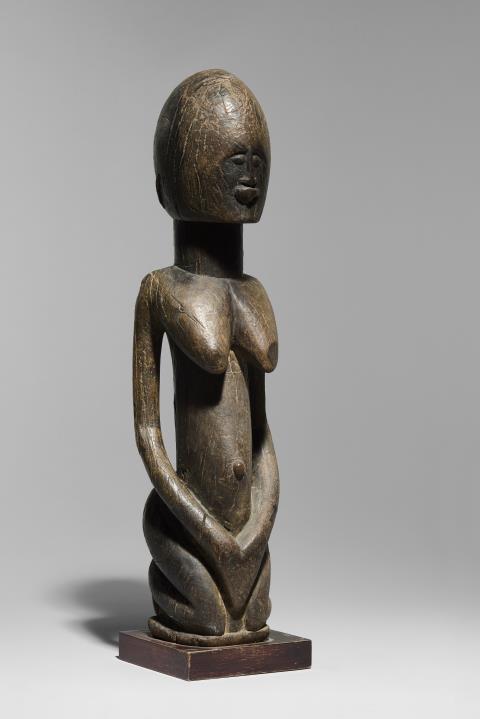 
    
            
                    A large female figure, Dogon
Mali
Wood, aged patina
A.D. 1318-1430 (QED 1904/C-0101)
                
        
